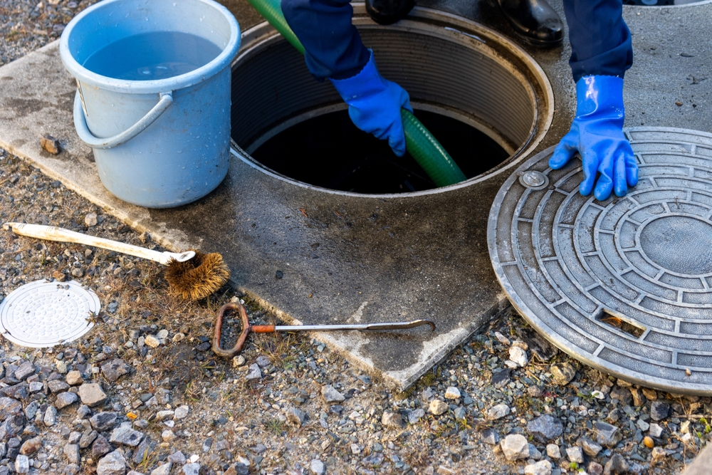 Image of a man cleaning a septic tank